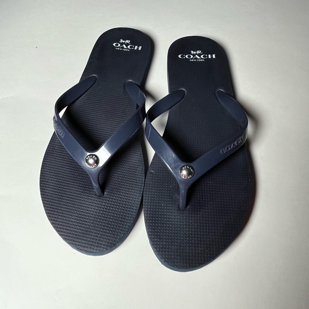Women’s Coach navy Zak flip flops.  Size 7-8.